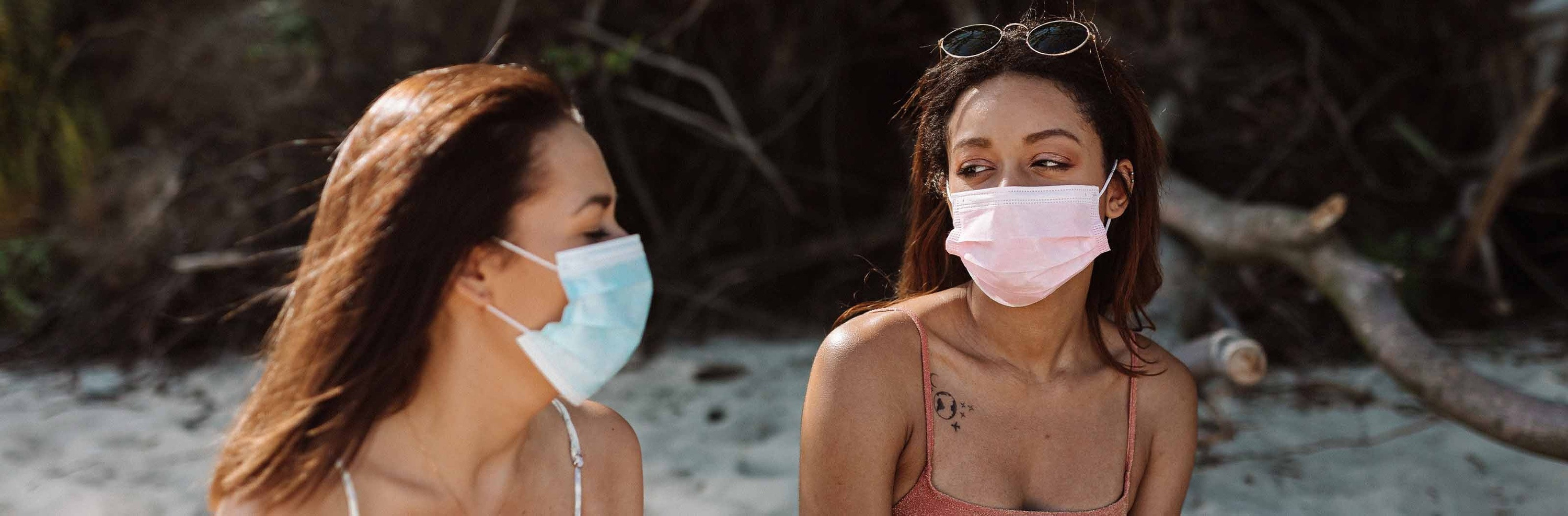 Ohtels: Corporativa, women in masks on the beach, relaxed atmosphere.