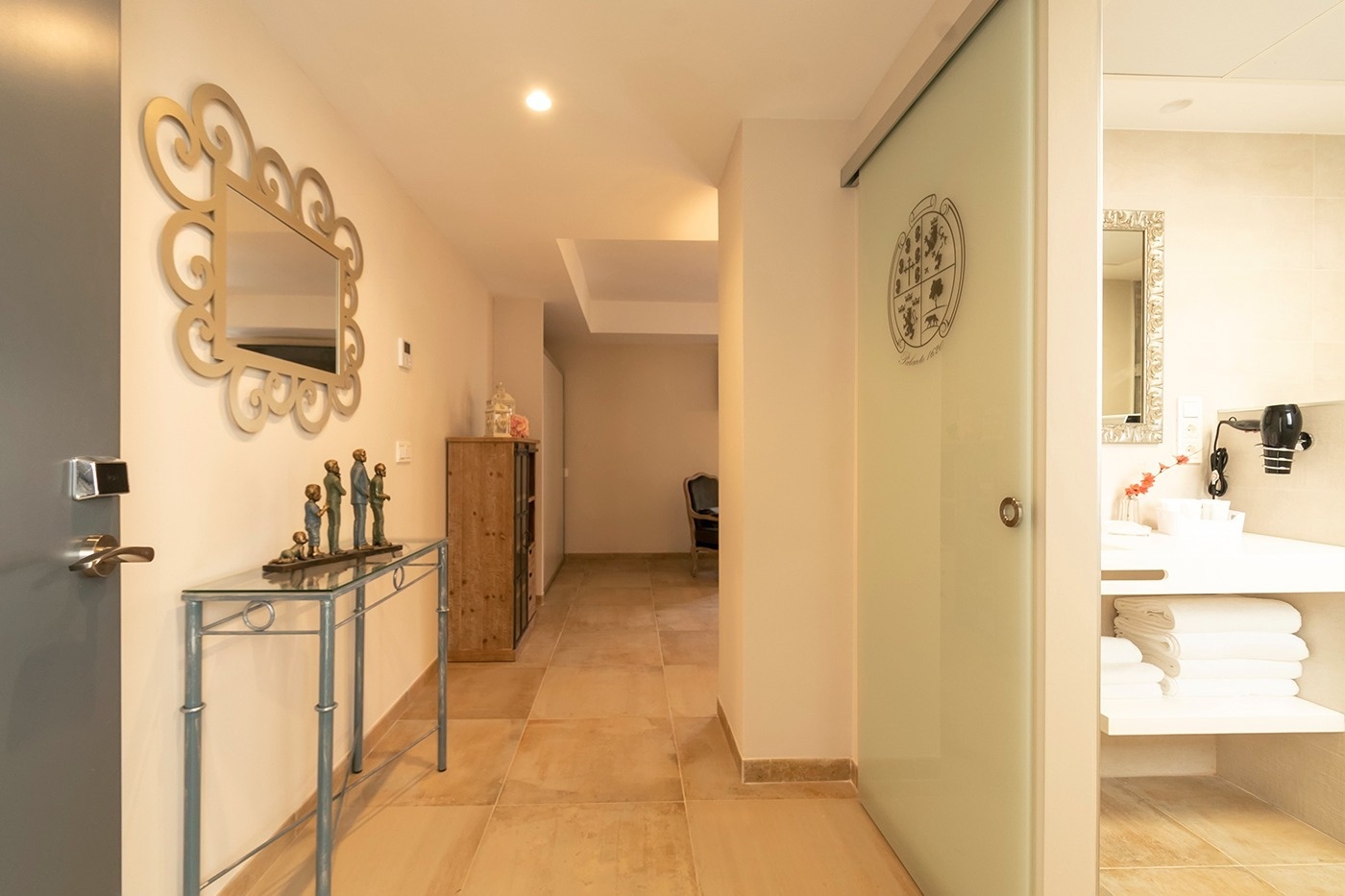 a hallway with a sliding glass door leading to a bathroom