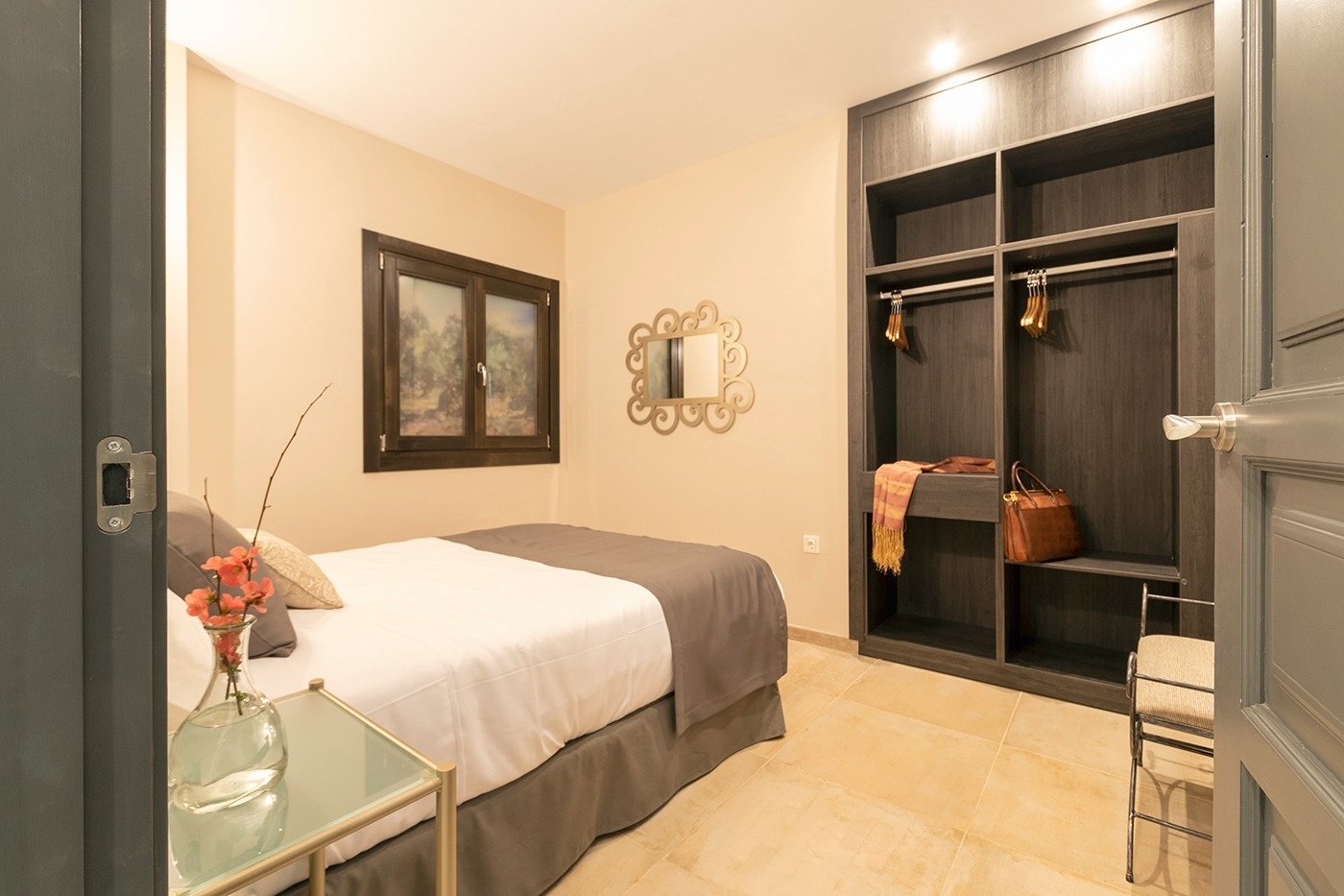 a bedroom with a bed and a mirror on the wall