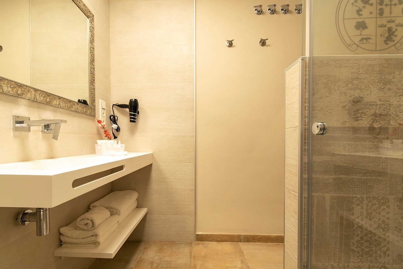 a bathroom with a sink a mirror and a hair dryer
