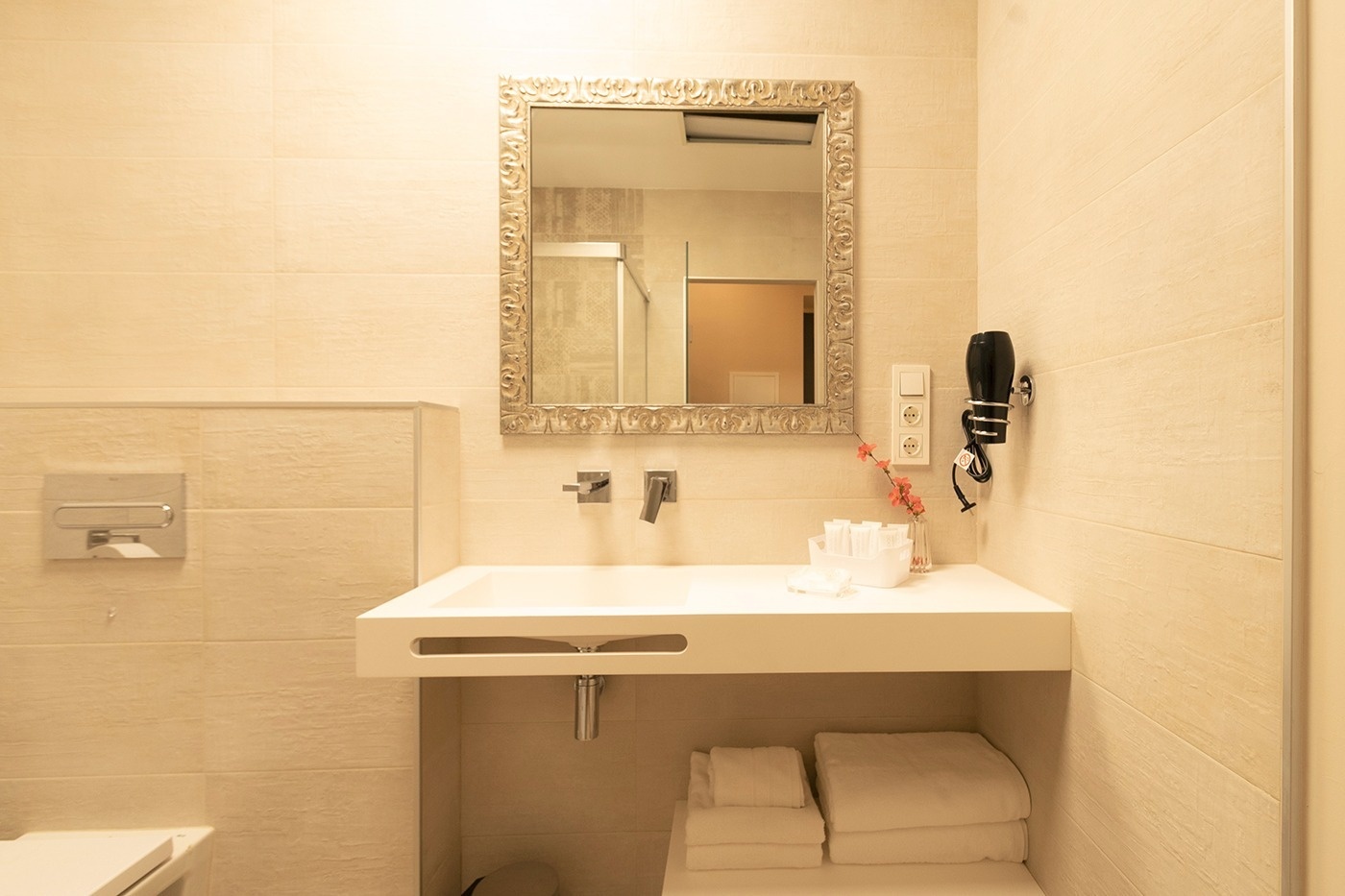 a bathroom with a sink a mirror and a hair dryer