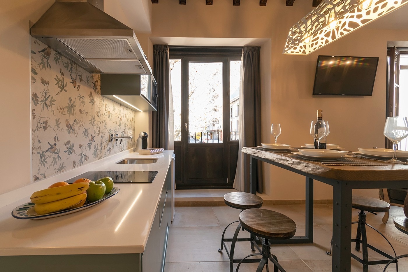 a kitchen with a wooden table and stools