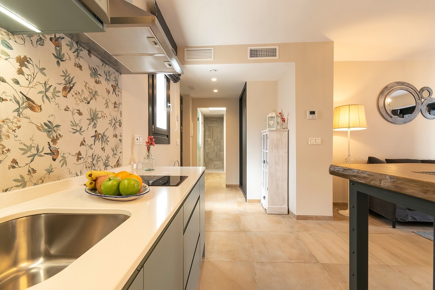 a room with a table and chairs with a view of the ocean