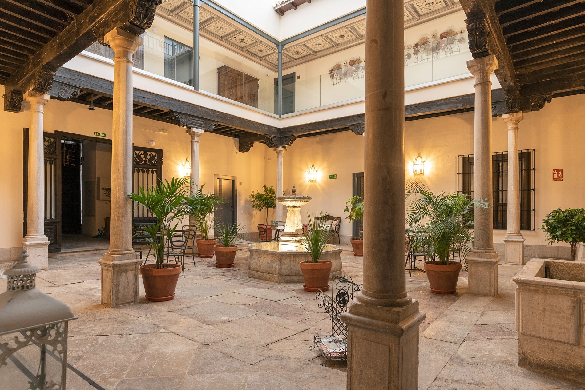 un edificio blanco con techo de tejas y balcones=s1900