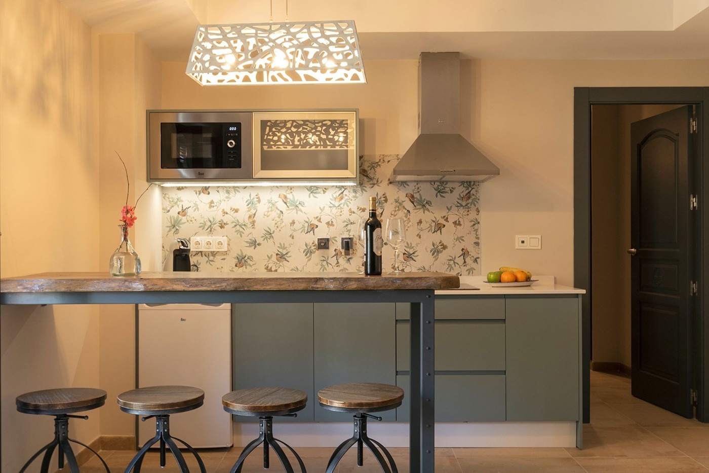 a kitchen with a bottle of wine on the counter