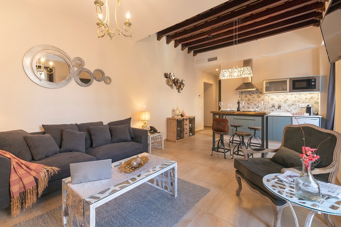 a living room with a couch and a table with a laptop on it