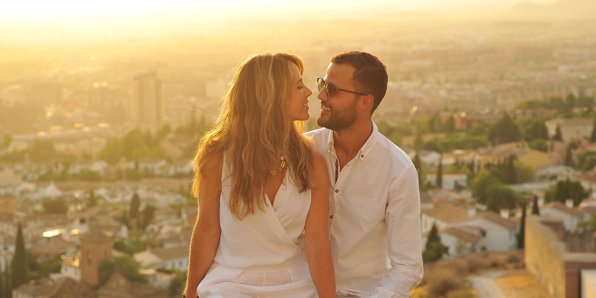 a large white building with a swimming pool in front of it
