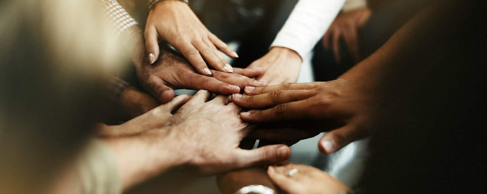 un grupo de personas pone sus manos juntas