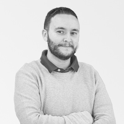 a man with a beard is wearing a grey sweater