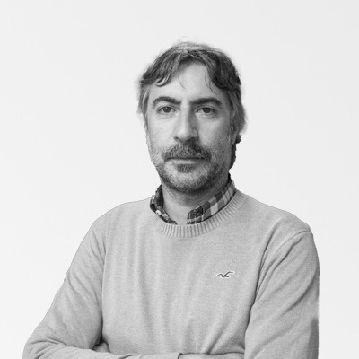 a man with a beard wears a grey sweater with a hollister logo on it