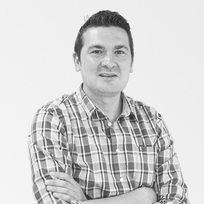 a man in a plaid shirt with his arms crossed