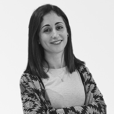 a black and white photo of a woman with her arms crossed