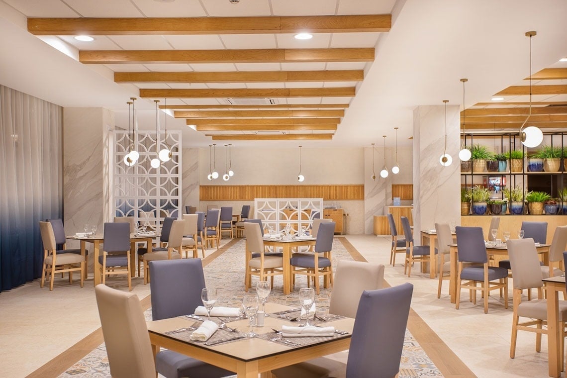 a dining room with tables and chairs set up for a meal