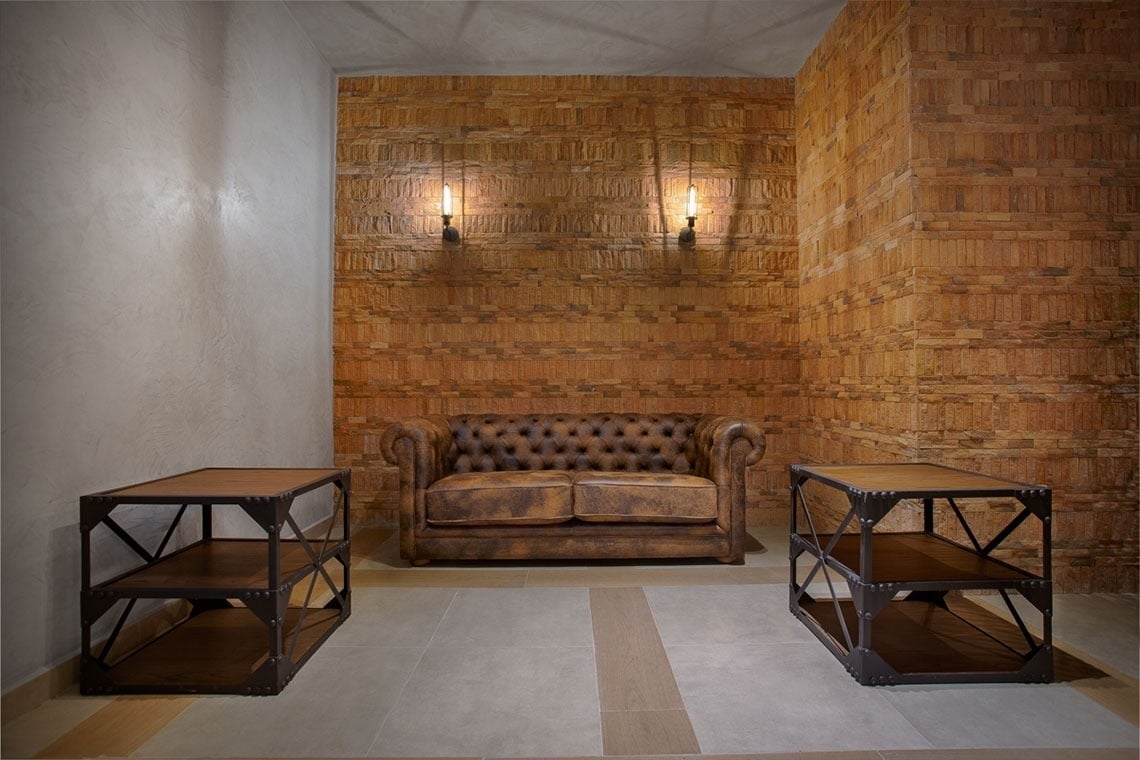 a living room with a couch and two end tables