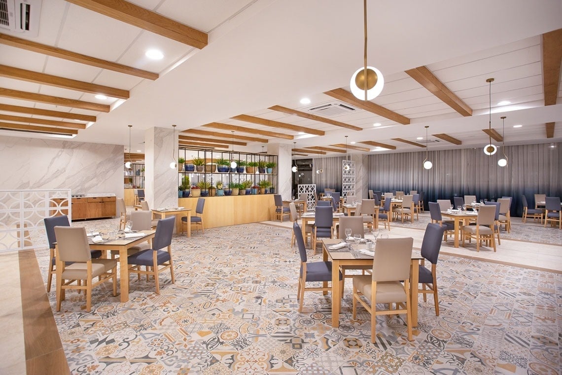 a restaurant with tables and chairs and a tiled floor