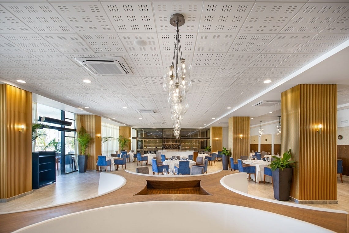 a large dining room with tables and chairs and a chandelier