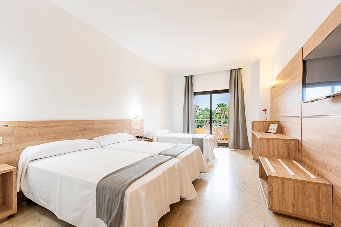 a hotel room with two beds and a television