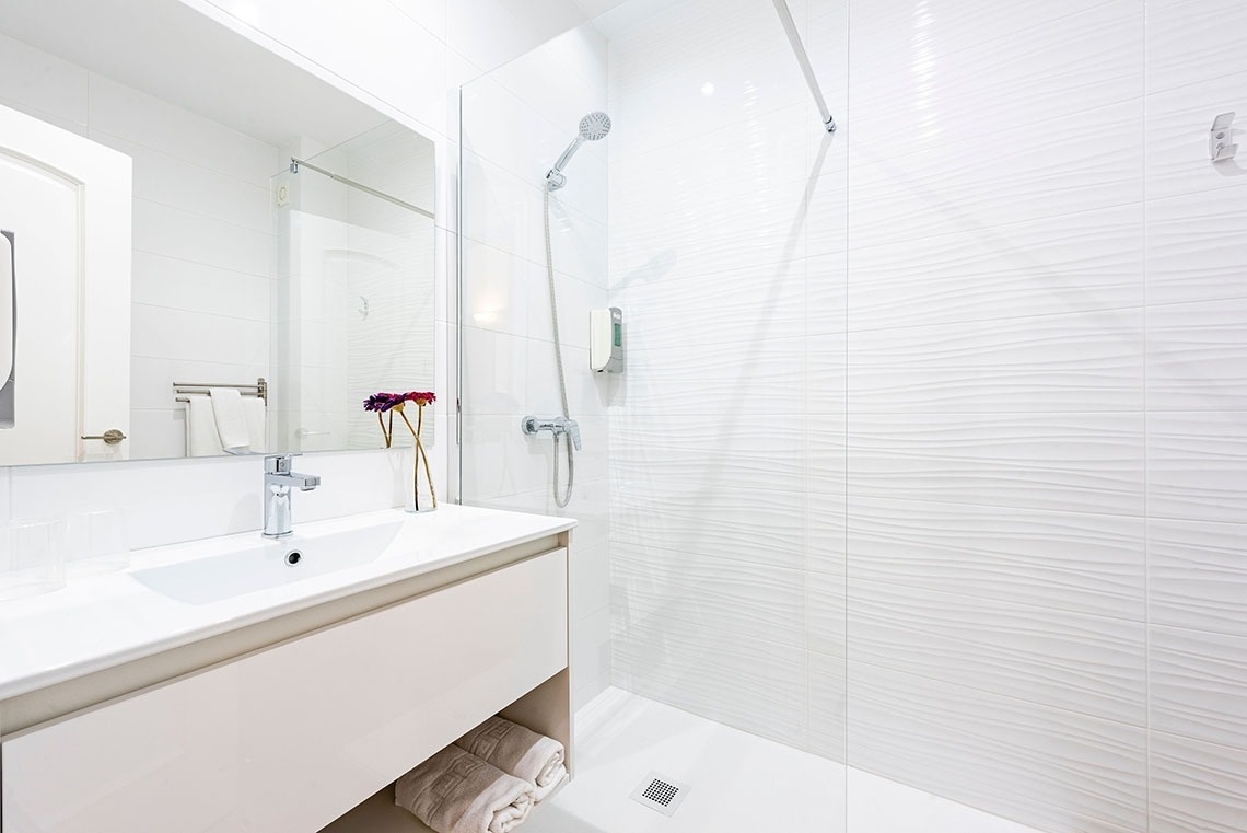 a bathroom with a sink and a walk in shower