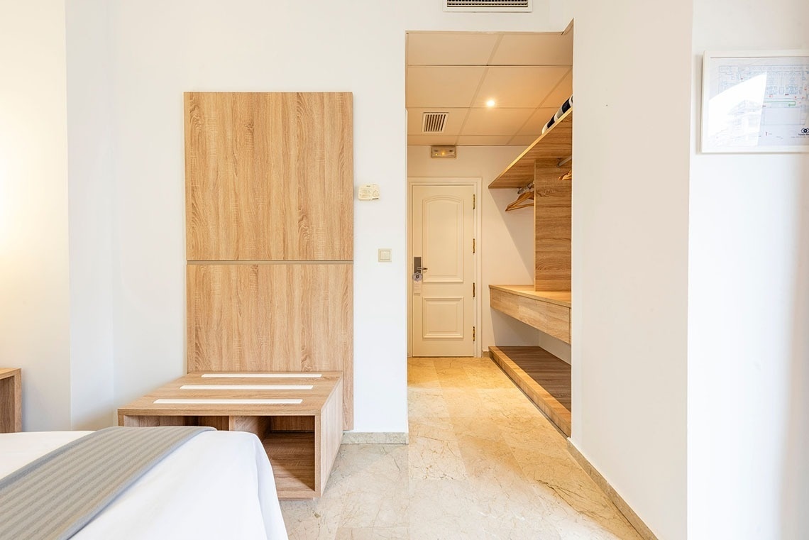 a bedroom with a walk in closet and a white door