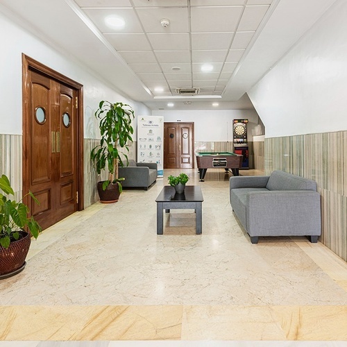 a hallway with a couch a table and a dart board