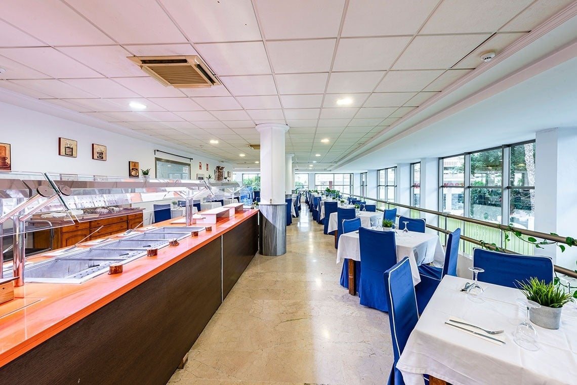 a restaurant with blue chairs and white tables