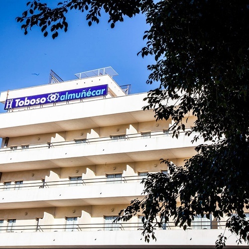 a building with a blue sign that says tobosa almunecar