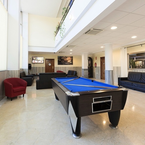 a pool table is in the middle of a living room