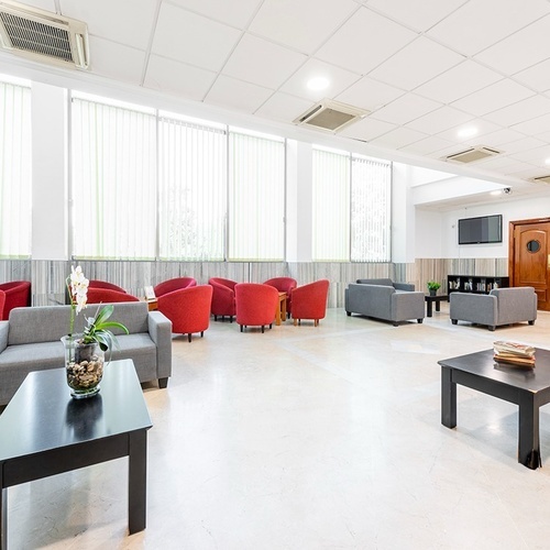 a living room with a lot of chairs and tables