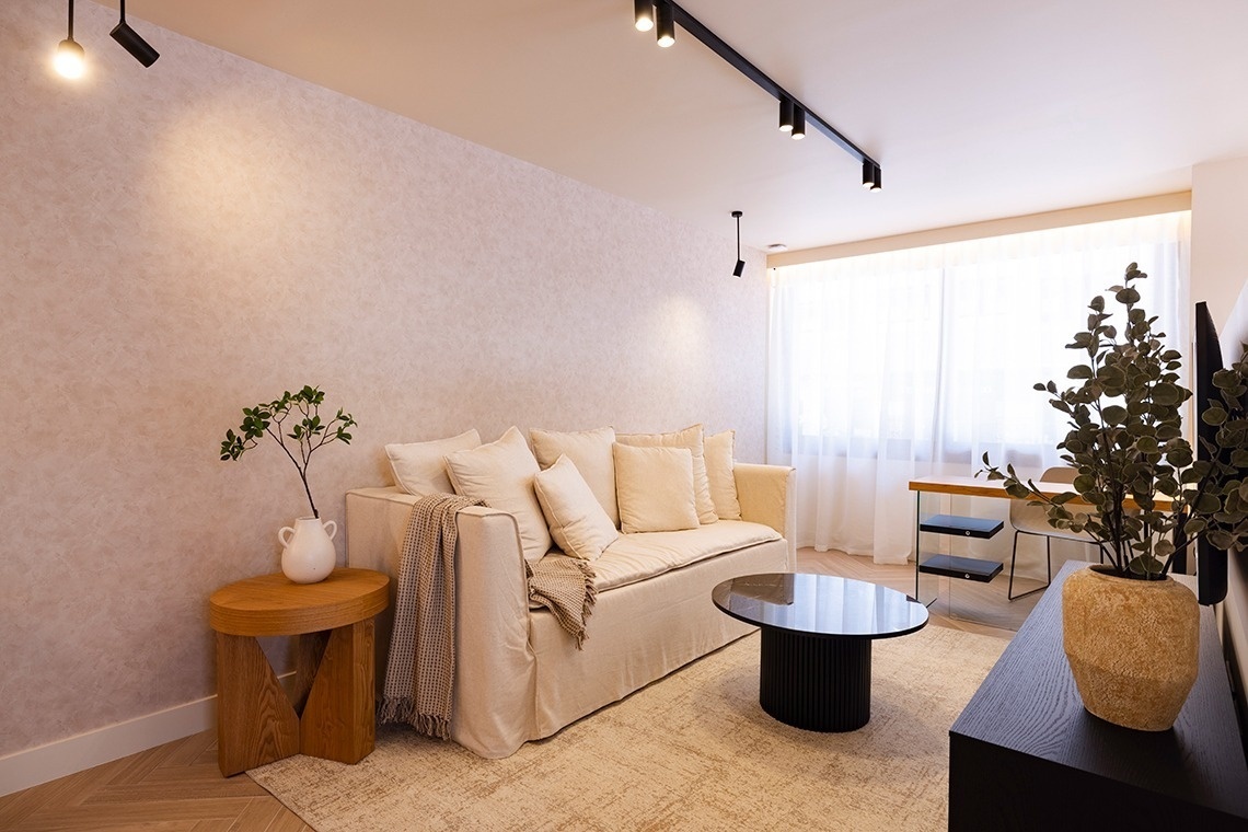 a living room with a white couch and a black coffee table