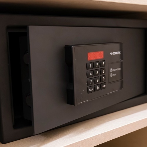 a dometic safe sits on a wooden shelf