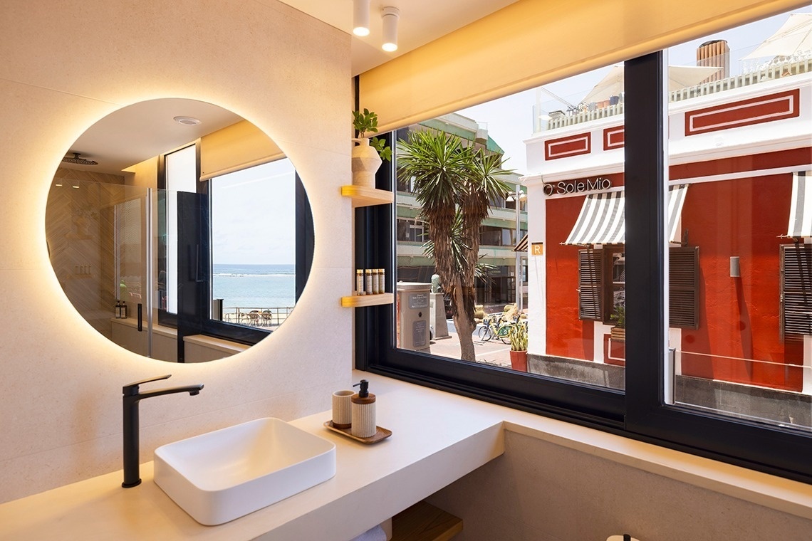 a bathroom with a sink and a mirror with the word osimo on the window