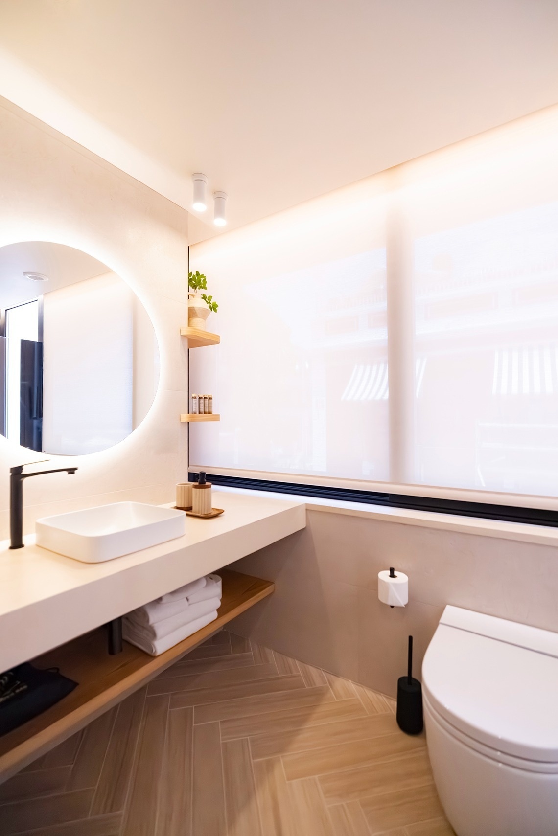 a bathroom with a toilet a sink and a mirror