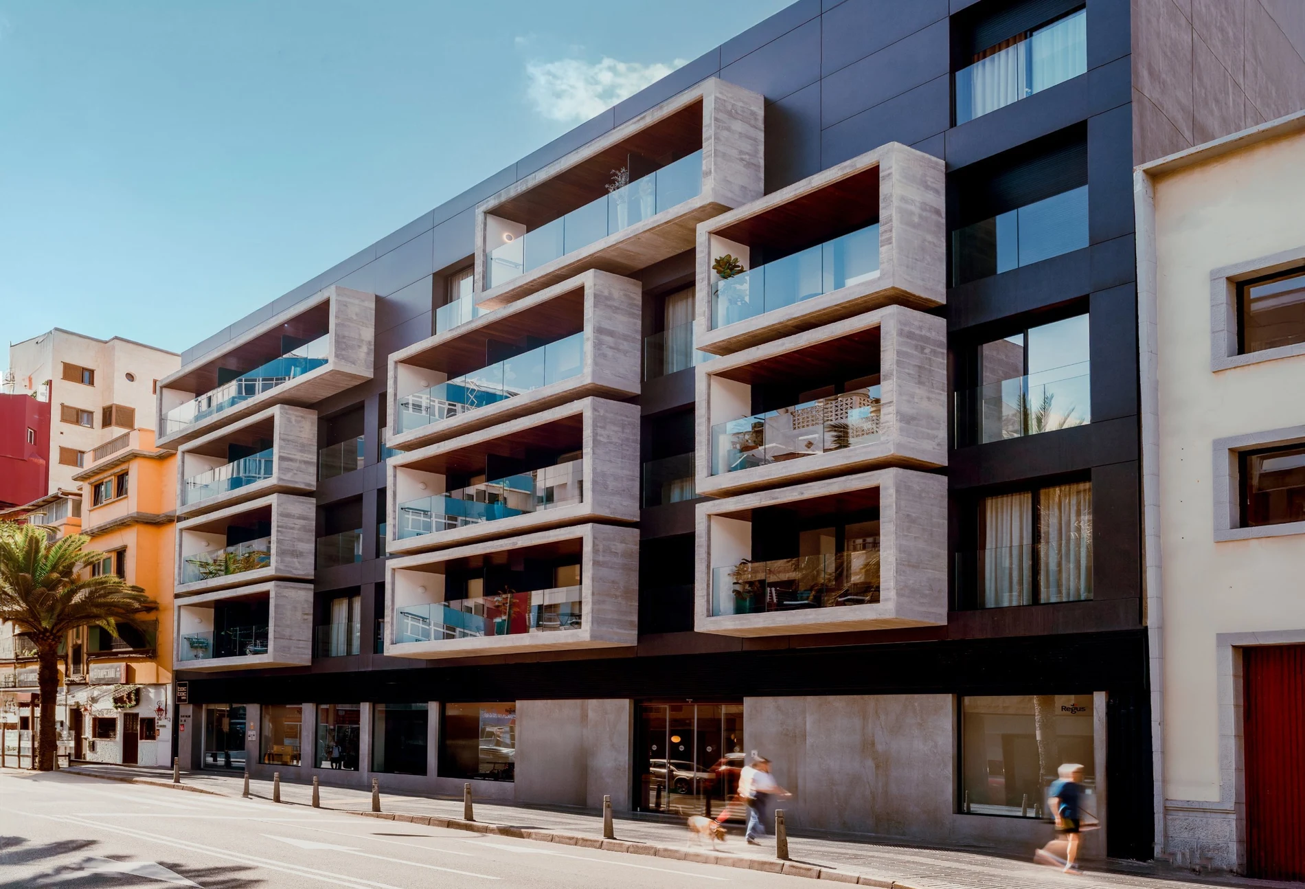 Edificio moderno con balcones de hormigón y cristales en TocToc Suites Olof Palme.