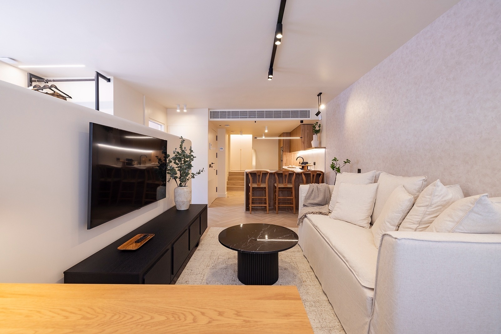 a living room with a couch and a desk with a laptop on it