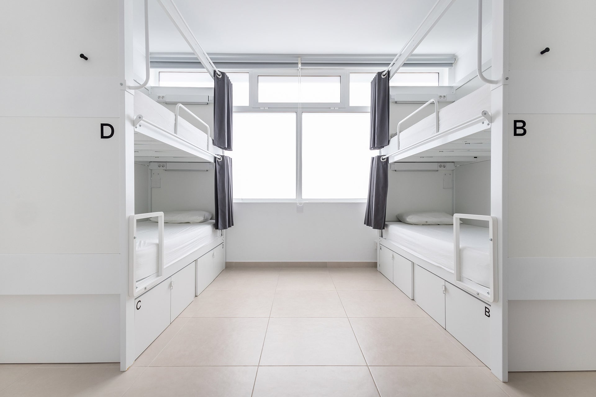 Modern hotel dorm room with bunk beds and private lockers. Dunas Hostel & Guesthouse | Torralvor | Official Website