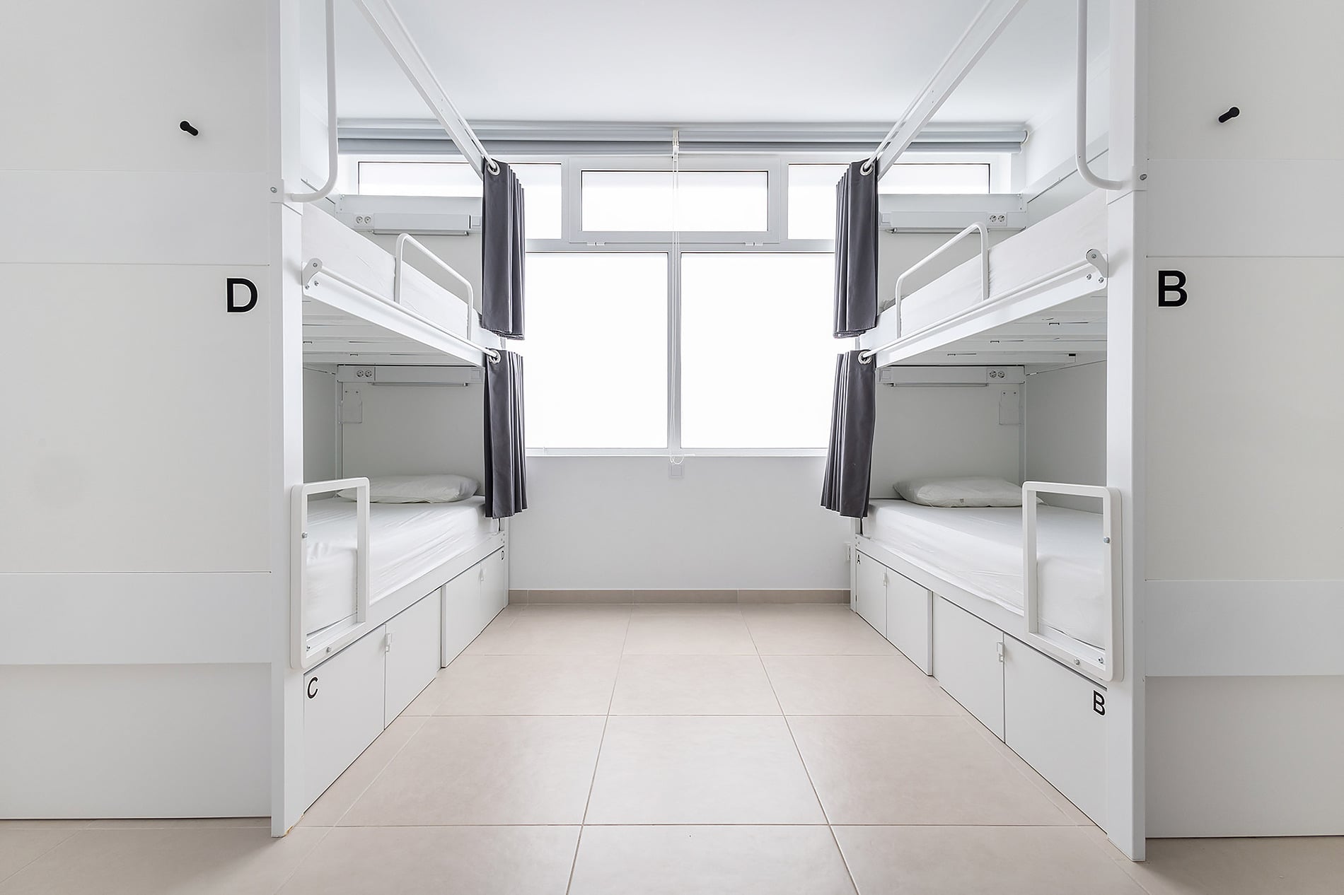 Modern hotel dorm room with bunk beds and private lockers. Dunas Hostel & Guesthouse | Torralvor | Official Website