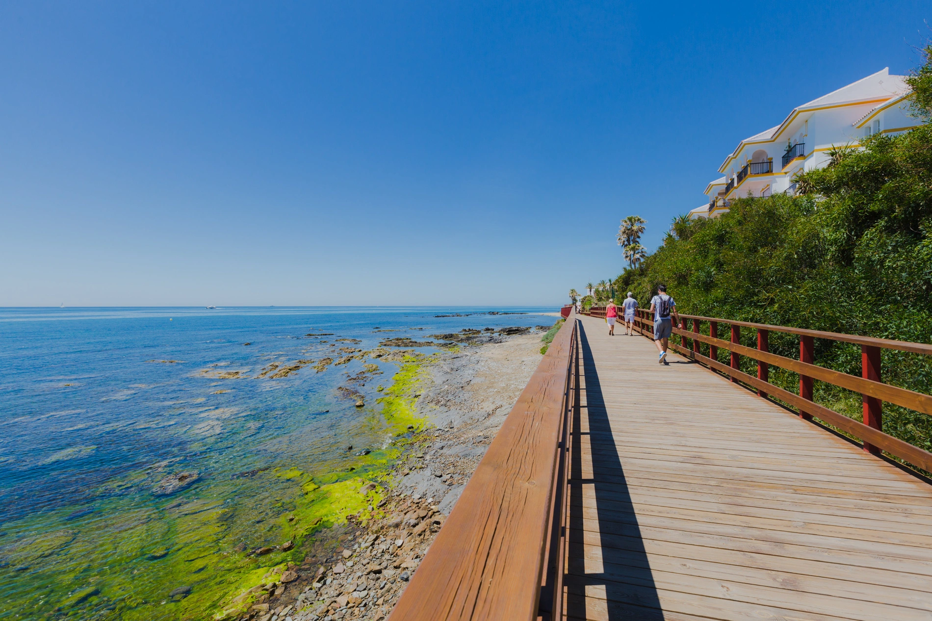 Boardwalk seaside resort walkway with ocean views and people walking Things to do in Mijas, Málaga | Torrenueva Park | Official Web