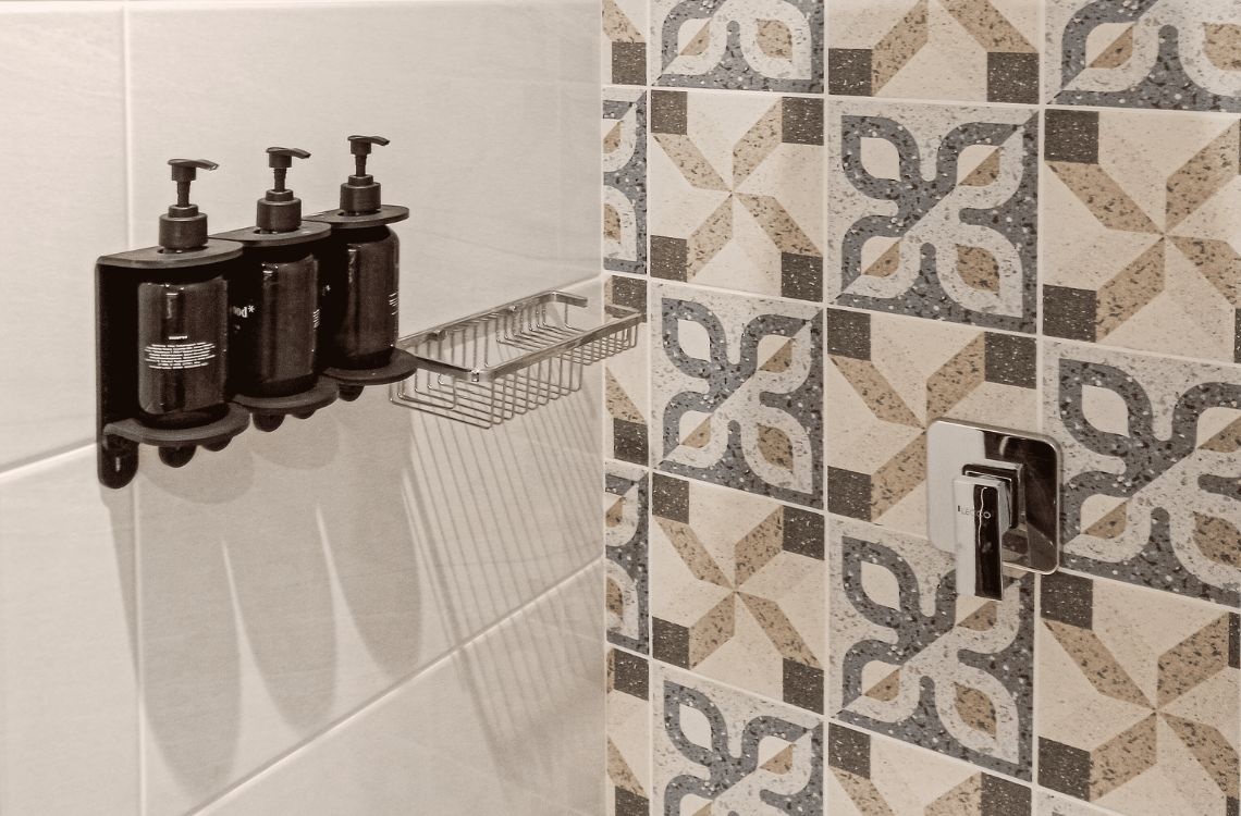 Modern shower caddy with soap dispensers, ideal for discerning travelers.