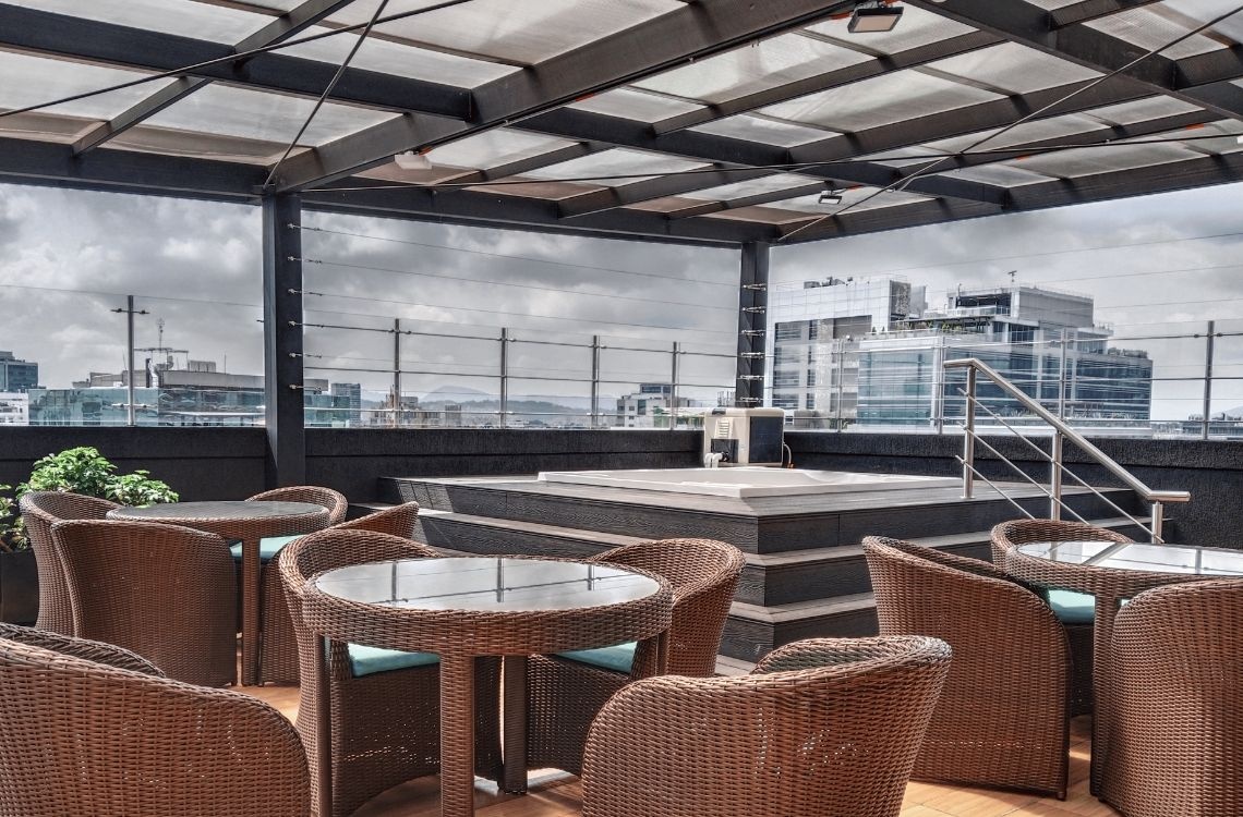 Rooftop jacuzzi and seating area with city views, perfect for corporate travelers.