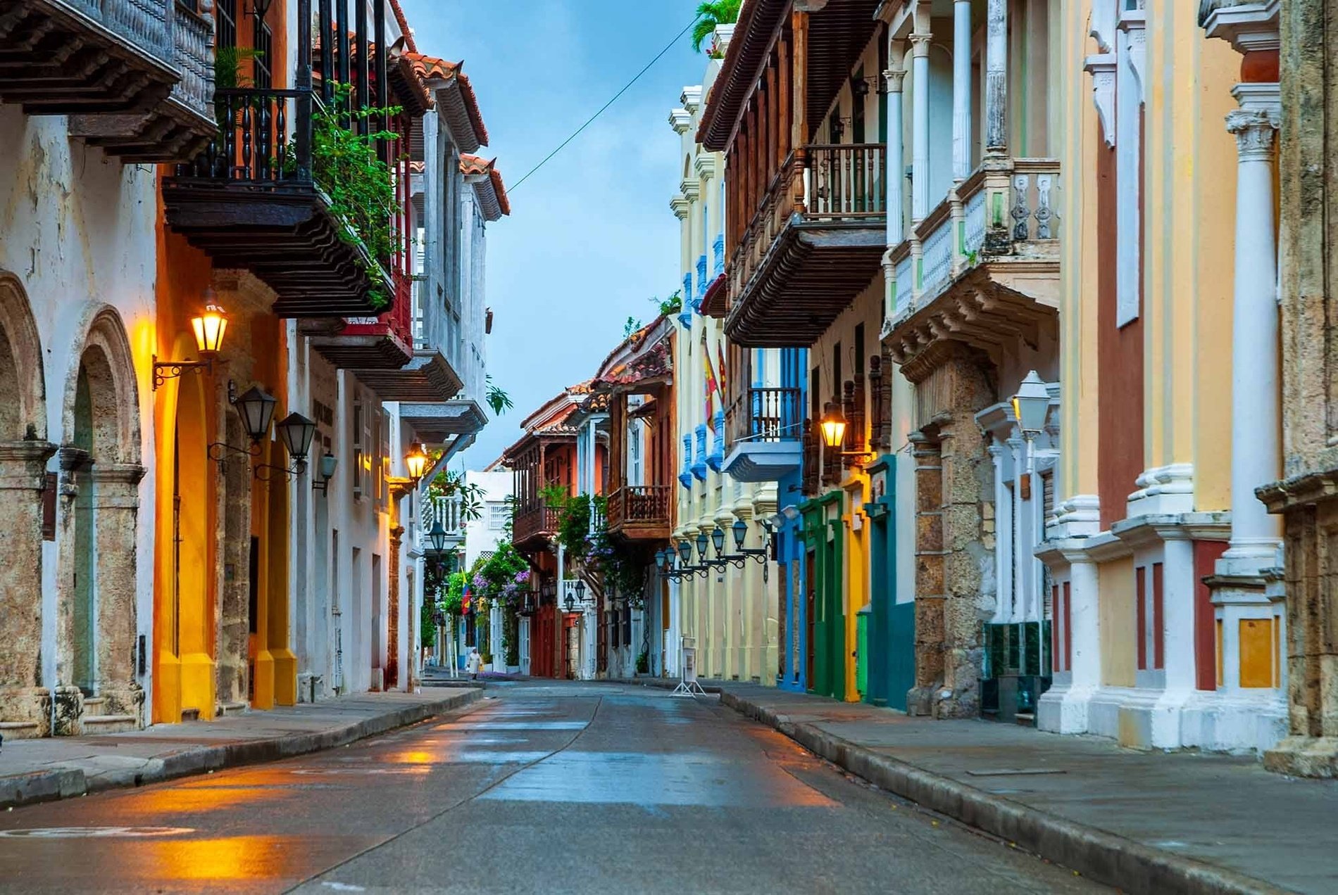 a row of buildings with balconies on the side of a street