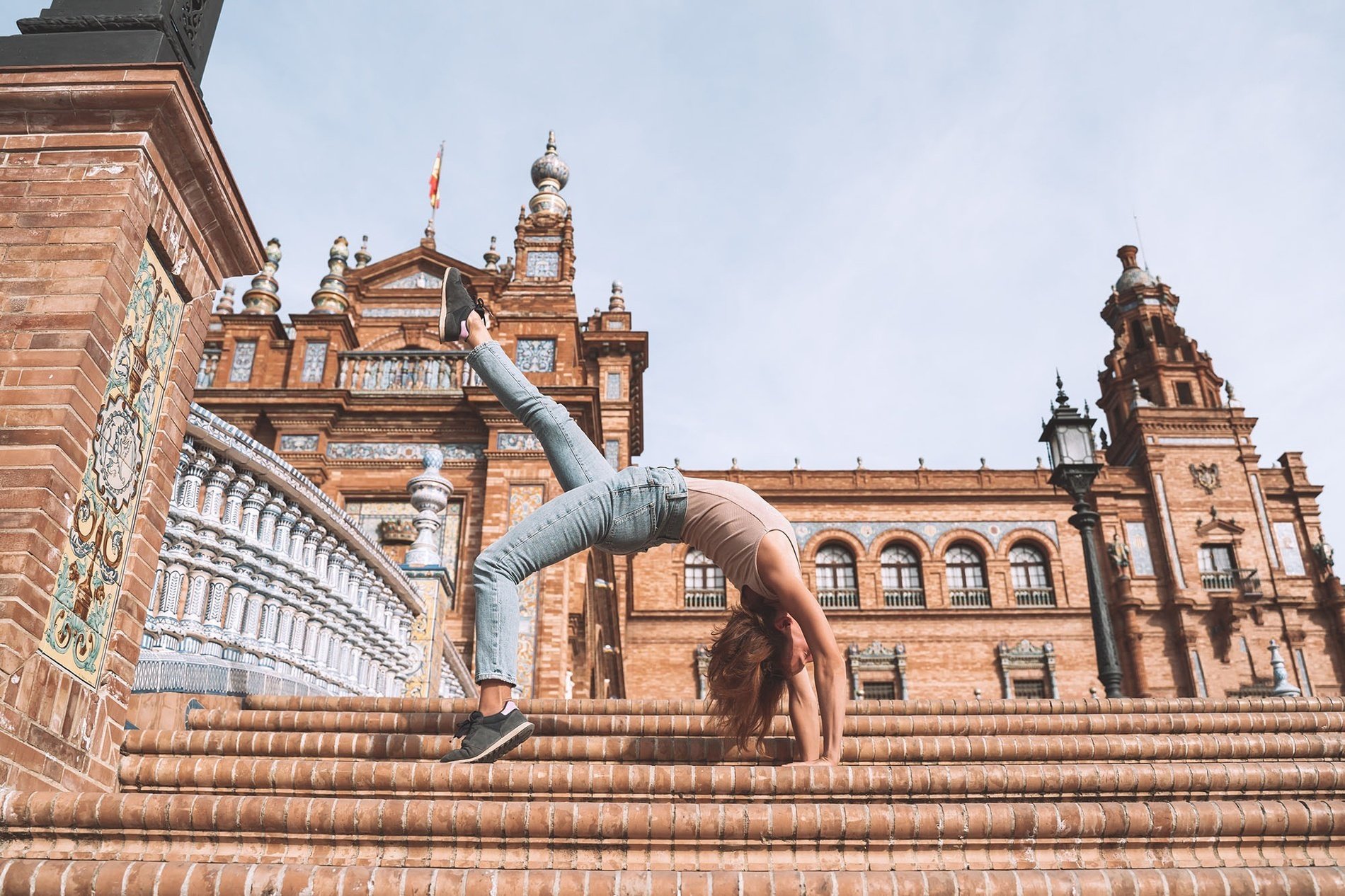 a woman doing a handstand on a set of stairs=s1900