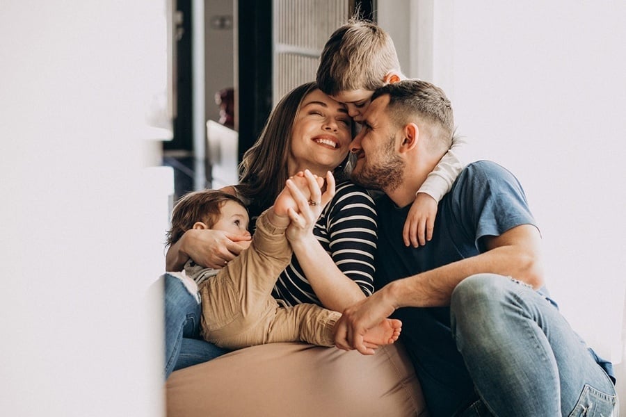 a family sitting on a couch with two children