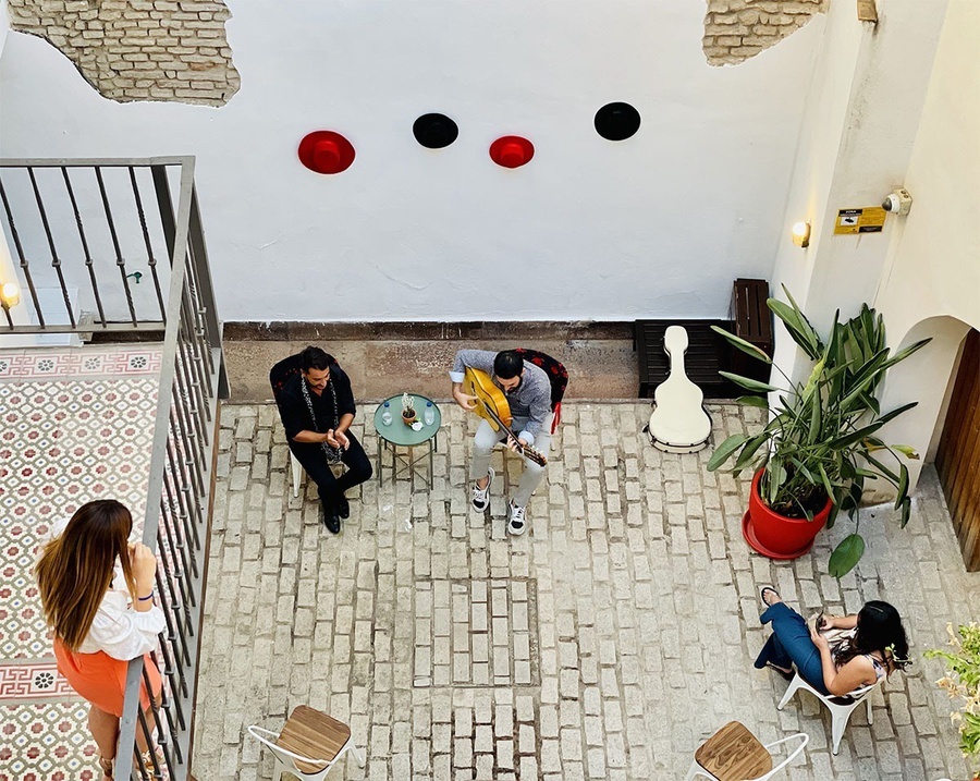 a group of people are playing instruments in a courtyard