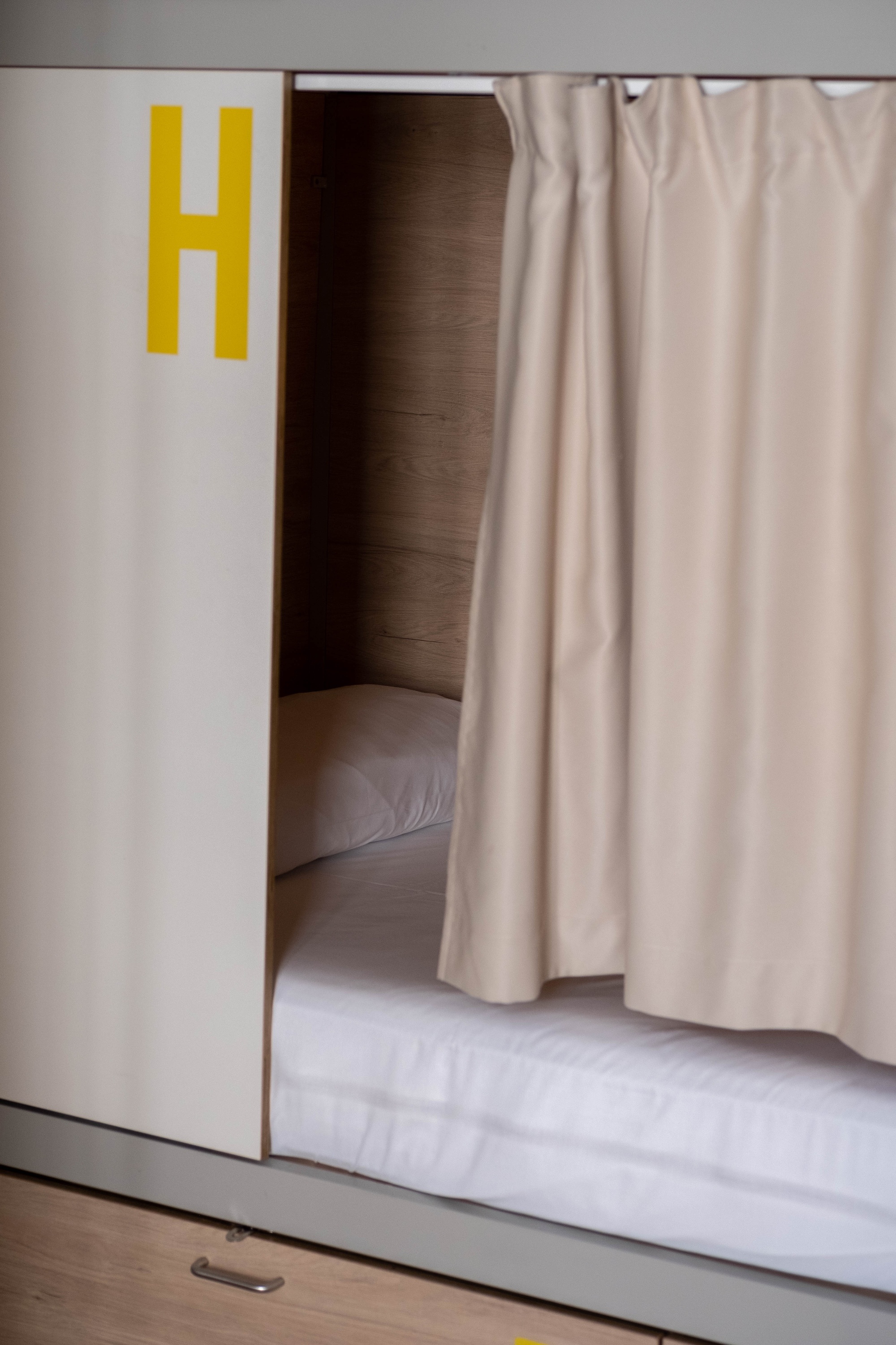 a bunk bed with the letter h painted on the wall