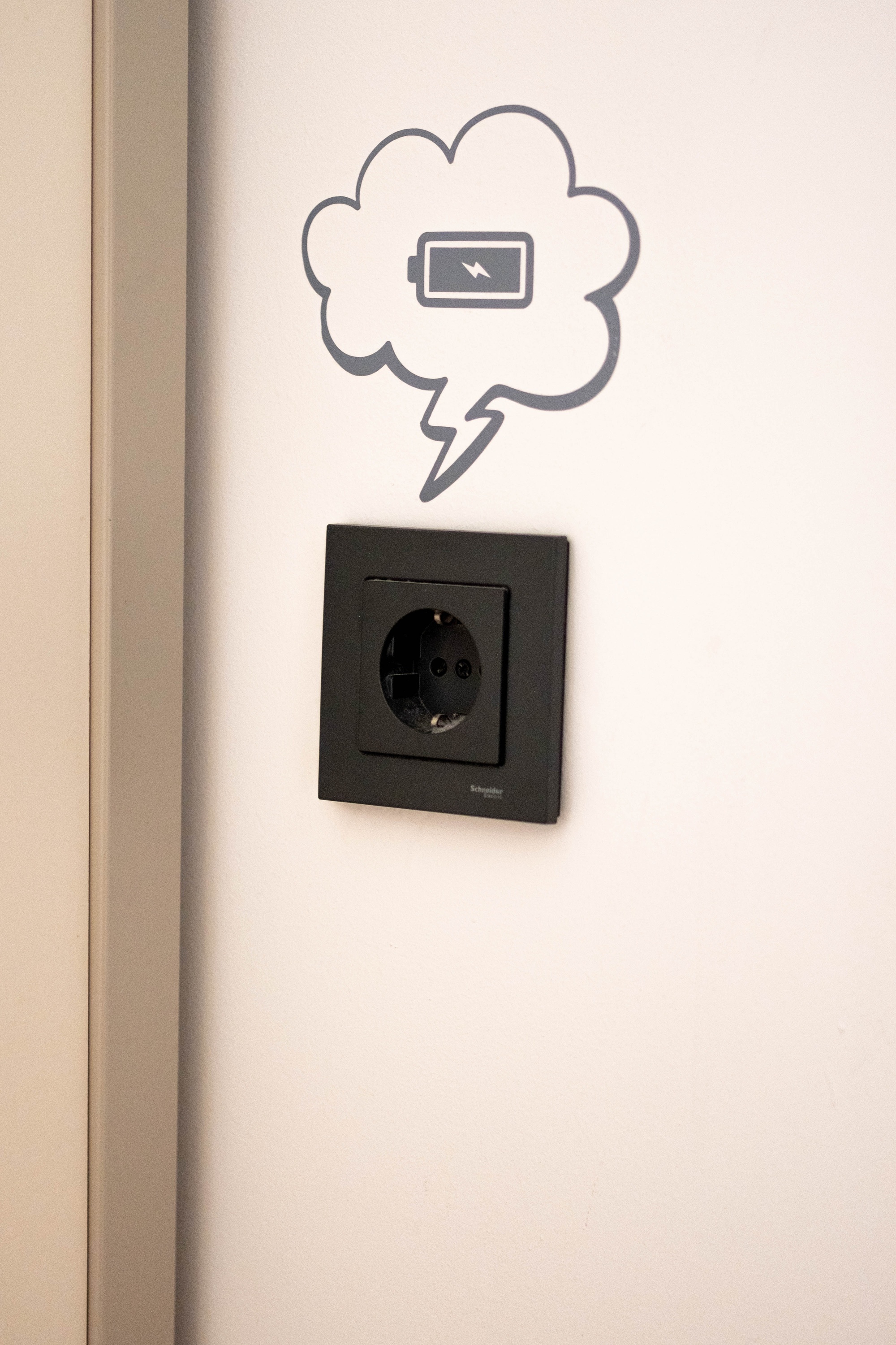 a light switch with a speech bubble with a battery in it