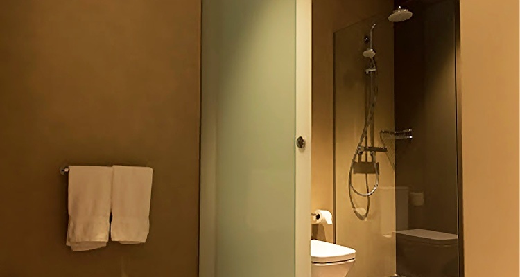 Baño moderno en Palacio Valderrabanos con ducha y toallas limpias.