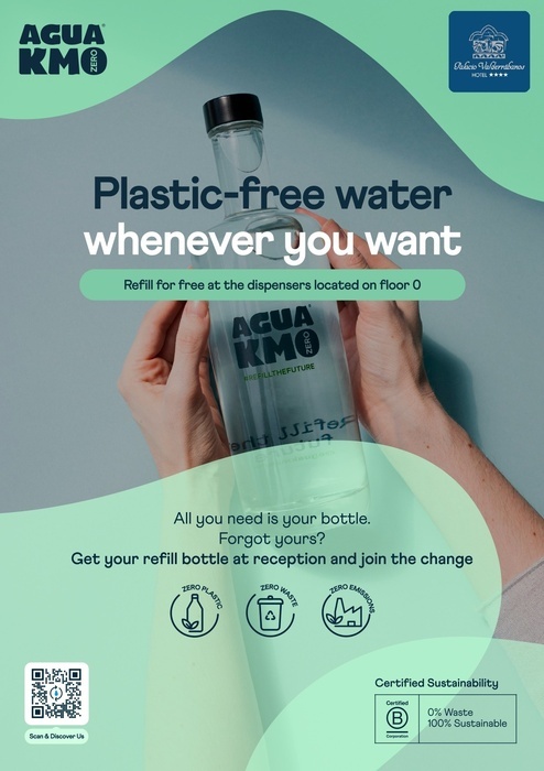 a person is holding a bottle of water in their hands .