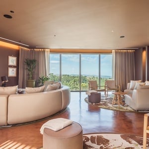 a living room with a large round couch and a flat screen tv