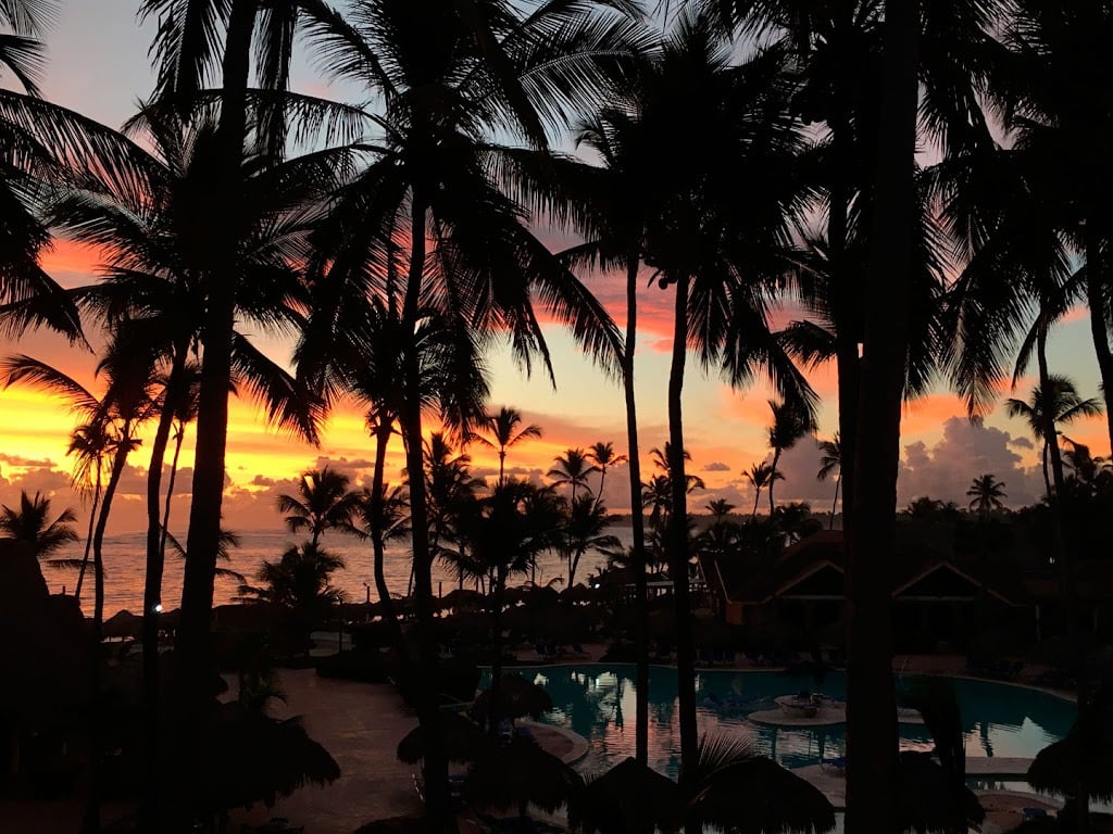 Tropical sunset over resort pool and palm trees VIK: Hotel Arena Blanca