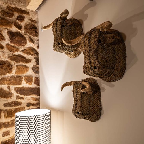 Rustic decor at Apartamentos Vilafames Antic Palau: woven bull heads.